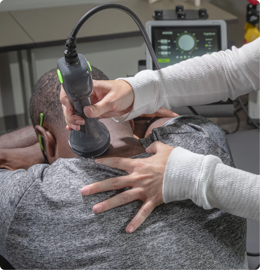 Clinician performing musculoskeletal ultrasound scan on patient's shoulder