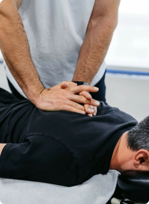 Chiropractor performing spinal manipulation on patient's lower back