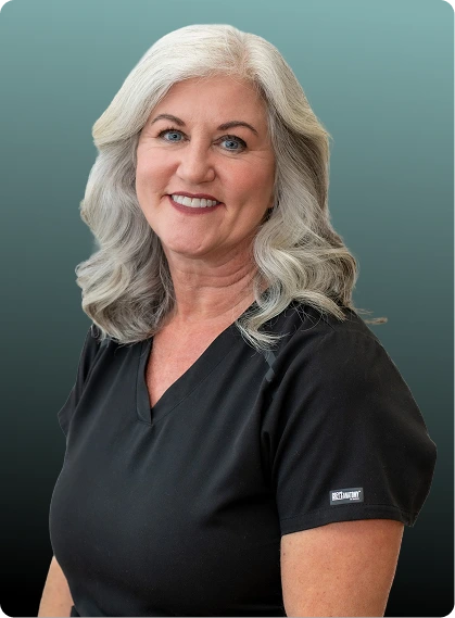 Female team member at Orlando Spine Studio in black scrubs