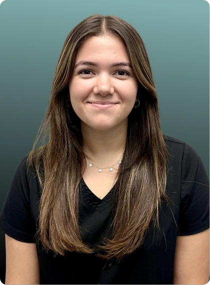 Female team member at Orlando Spine Studio in black scrubs