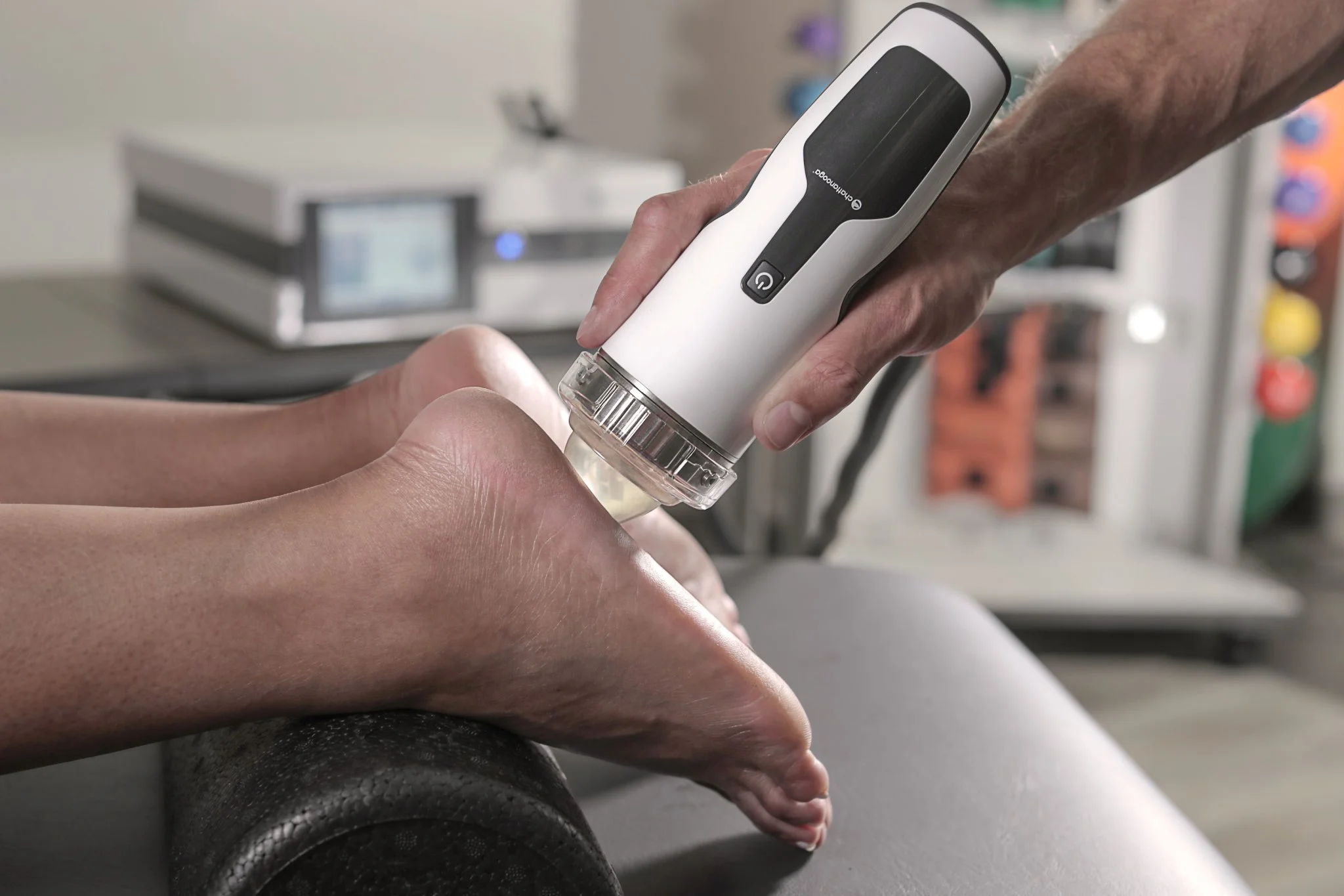 Shockwave therapy applied to the heel of a patient’s foot